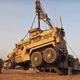 Illustration for article titled It Takes Three Extreme Machines To Flatbed An MRAP With A Blown Tire
